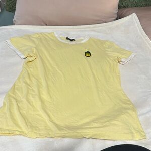Pale yellow shirt with pineapple embellishment